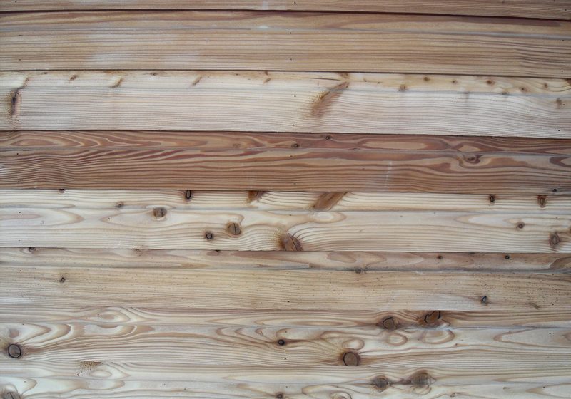 A close-up of natural pine floorboards with visible grain and knots